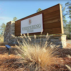 Whispering Pines neighborhood by Oconee Capital Home Builders entrance sign.